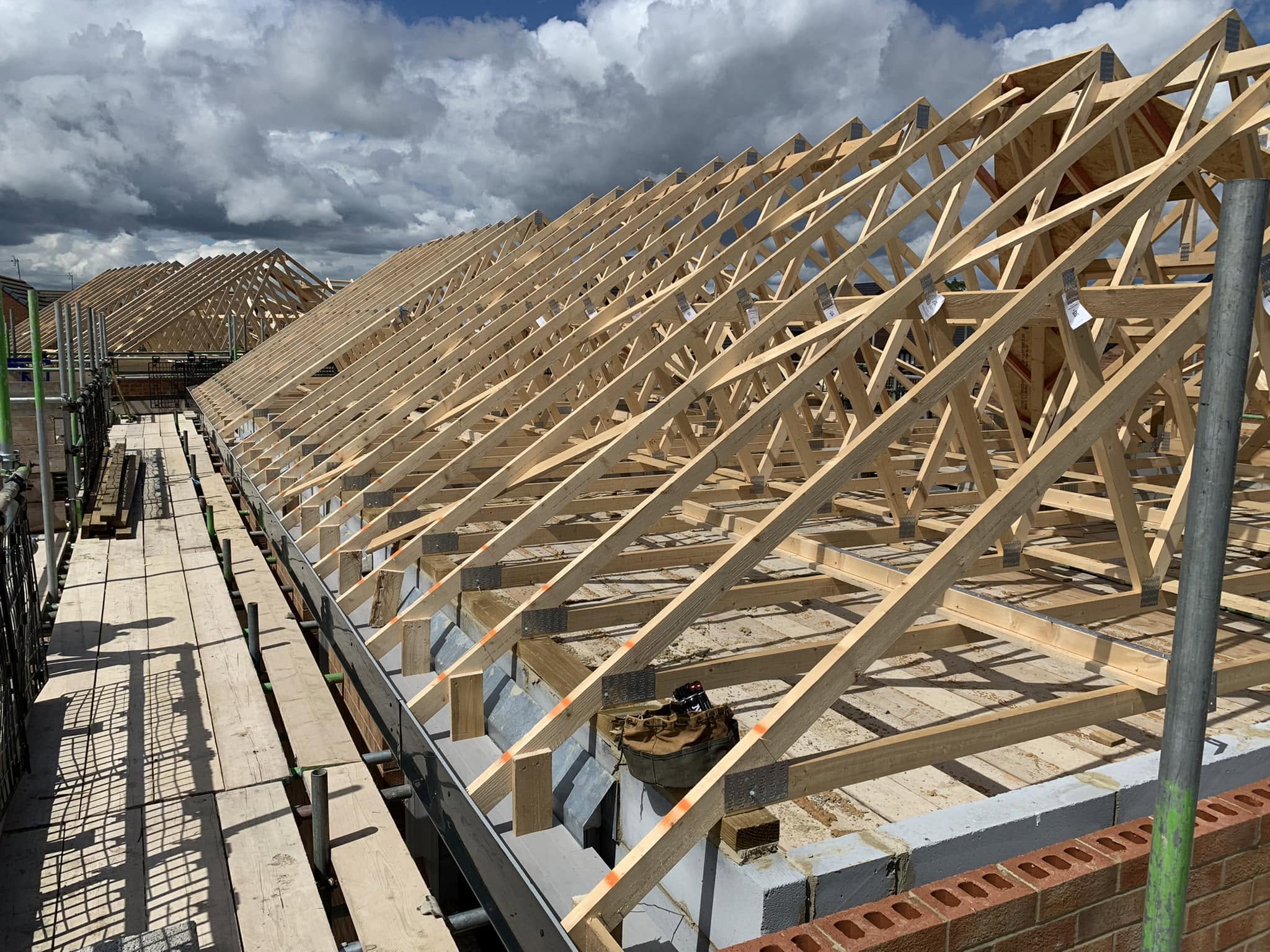 Completed Roof Truss Structure Along Scaffolding